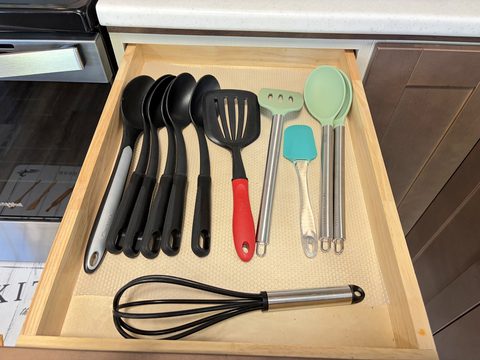Drawers stocked with cooking utensils, so you can make a real meal