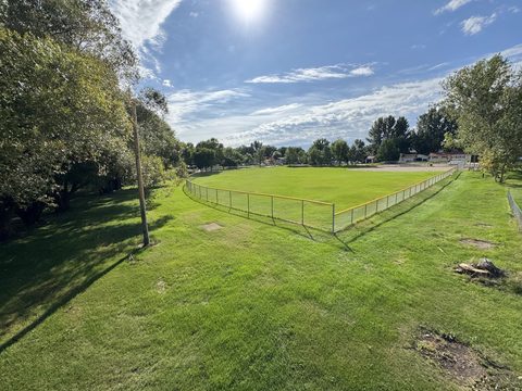 Out back, the park begins: a ball field ready for a game of catch