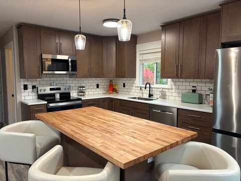 Brand new appliances and a butcher block island, made for cooking together