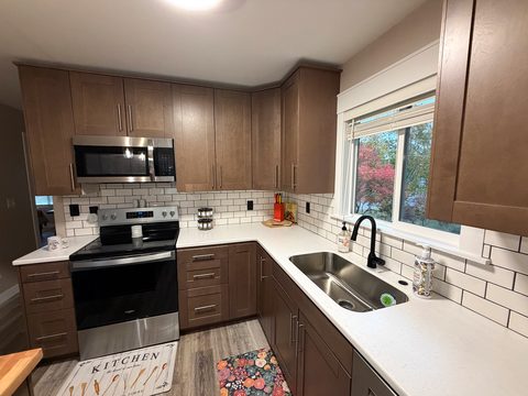 Brand new stove and microwave, with a window over the sink for the view