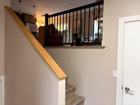 Half a flight down: a second living room, two more bedrooms and a full bath