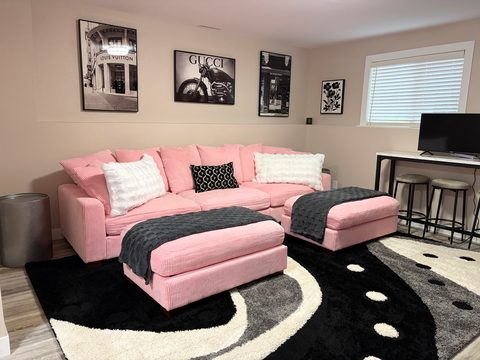 A second living room for the group, with a huge sectional and two ottomans