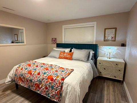 A bedside lamp and nightstand within reach, plus room to unpack
