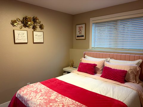 A light and bright lower level, with a queen bed in luxury bedding