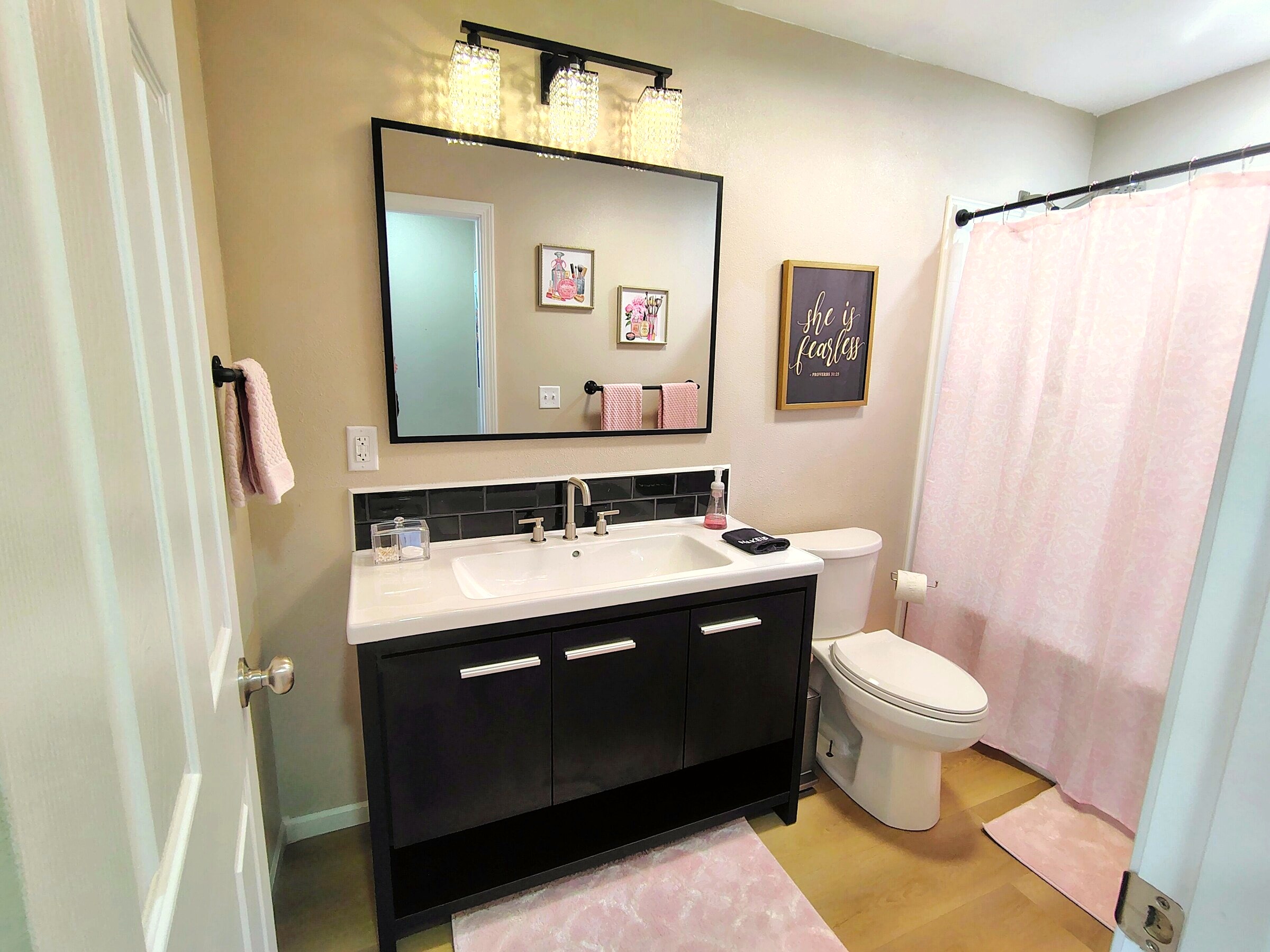 Full bathroom with black vanity